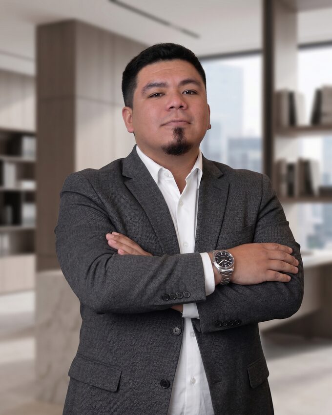 Jean Paul Diaz in a gray blazer with arms crossed